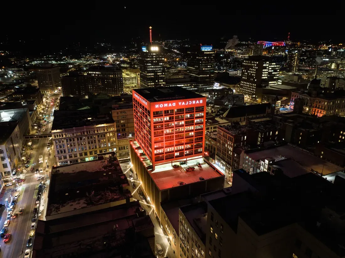 A drone image of the city of Syracuse at night.